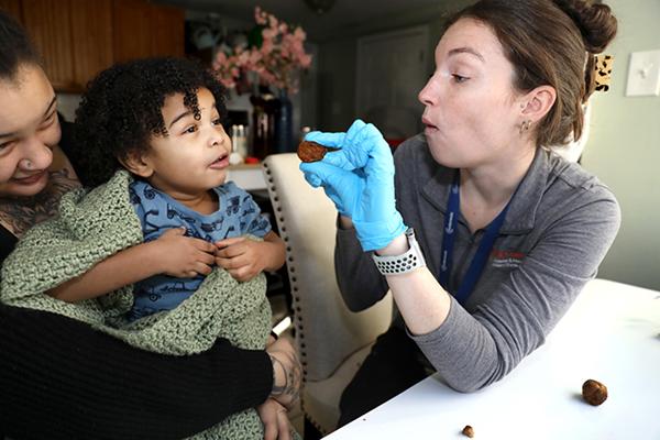 A child in feeding therapy being encouraged by therapist