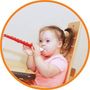 Child with Down syndrome plays music on a recorder