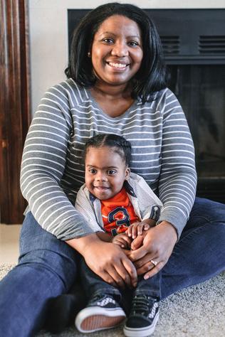 toddler boy with mom sitting on carpet smiling