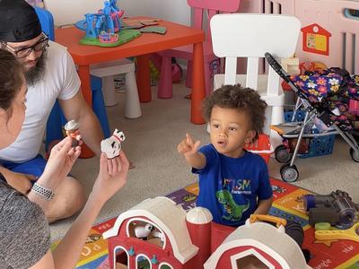 young boy playing with toys with a occupational therapist