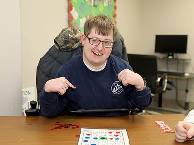 Young adult male with a disability playing bingo