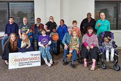 A group of people with various disabilities all posing together